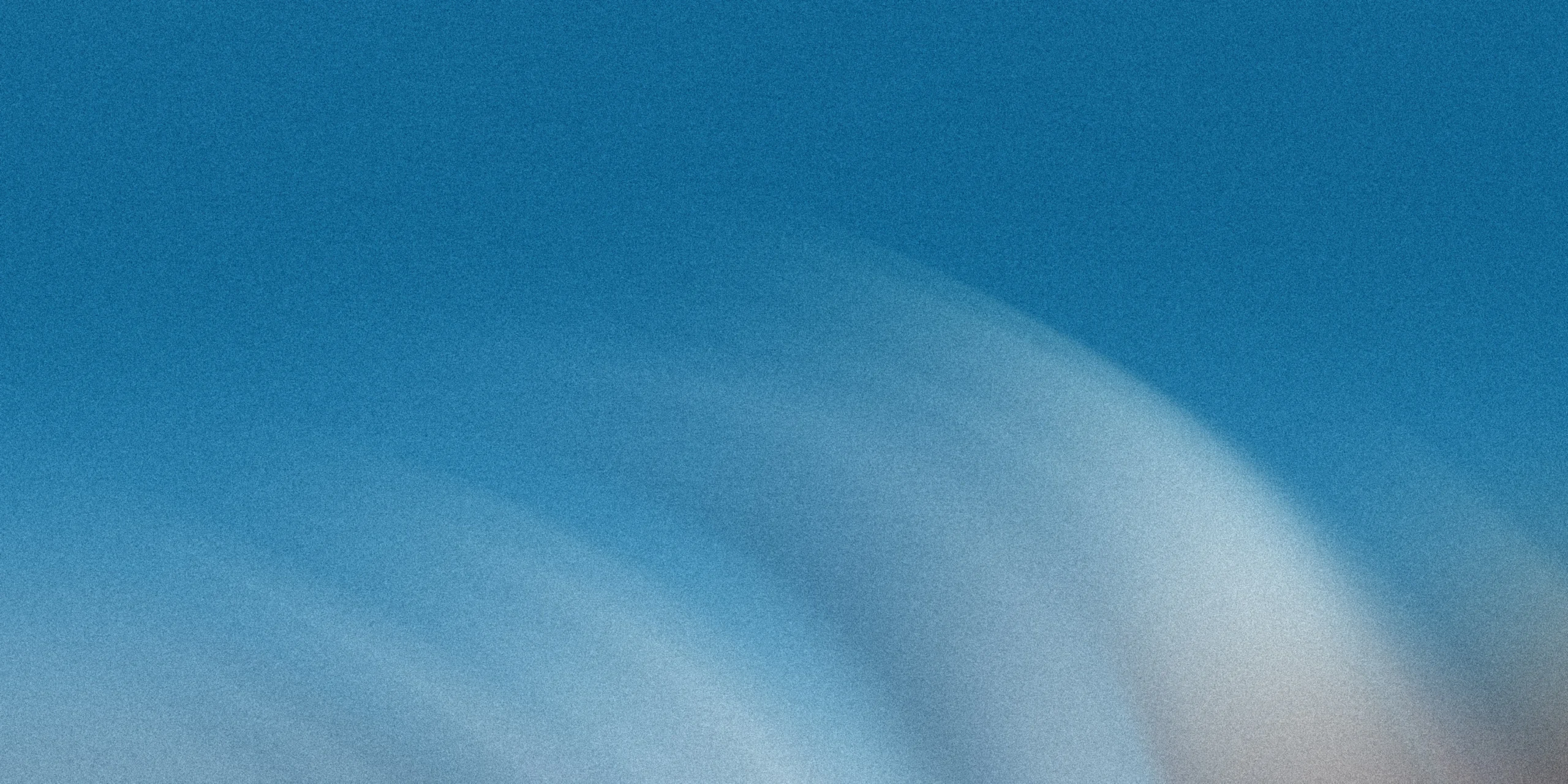 blurred abstract background with gradient blue white creates textured grainy visual effect